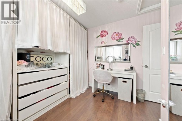 Bedroom with makeup vanity, gold chair, mirrored closet, and floral decals - 71 Riviera Ridge Stoney Creek