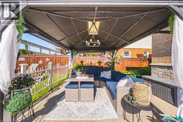 Gazebo with sectional sofa, dining table, and outdoor rug - 71 Riviera Ridge Stoney Creek