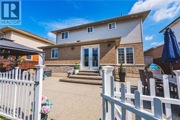 Backyard with patio, fence, gazebo, and outdoor dining set - 71 Riviera Ridge Stoney Creek