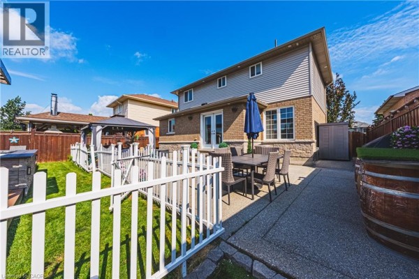 Backyard with patio, dining set, gazebo, fence & barrel planters - 71 Riviera Ridge Stoney Creek