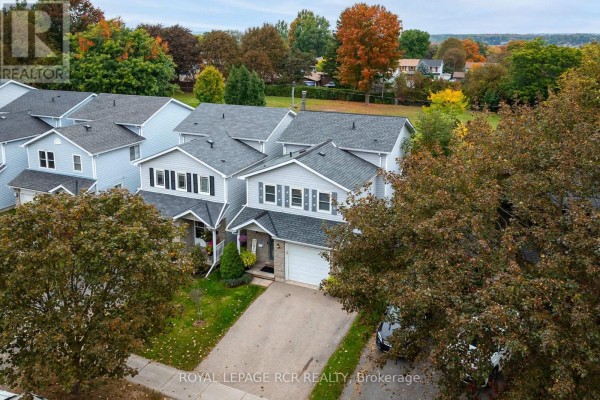 Aerial view of multiple residential houses with grey siding and dark roofs. - 71 Shirley Street, Orangeville