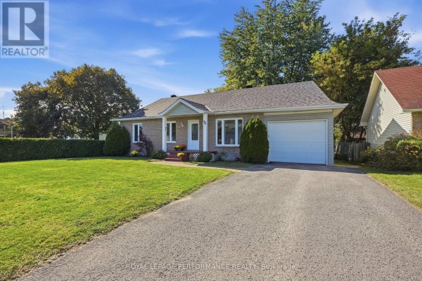 Driveway leading to a single-story brick house with an attached garage. - 71 Stephens Street, Champlain