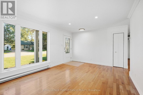 Interior view of a bright living room with large windows and hardwood flooring. - 71 Stephens Street, Champlain