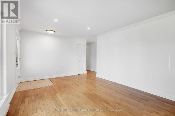 Living room showcasing hardwood floors and access to other areas of the home. - 71 Stephens Street, Champlain