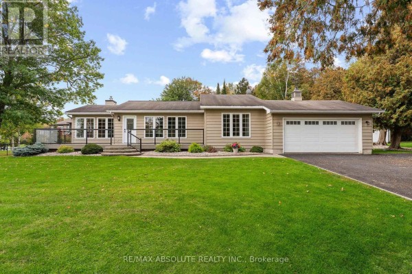 Front exterior of a beige, single-story house with a paved driveway and green lawn. - 71 Toner Road, Mcnab/braeside