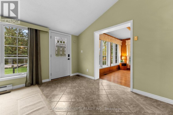 Interior view of an entryway with beige tile floor, light green walls, and a large window. - 71 Toner Road, Mcnab/braeside