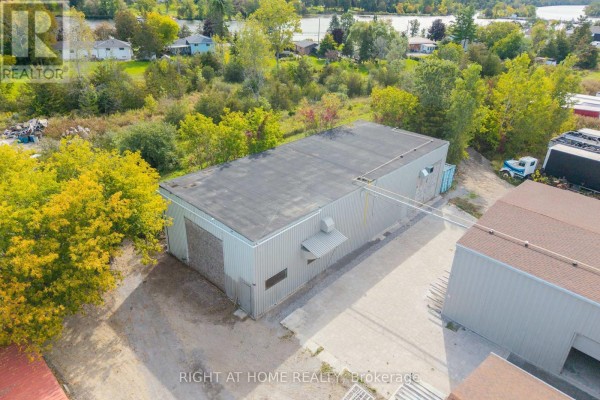 Aerial view of a long, grey industrial building with a flat roof and an adjacent section of the property. - 71 Wolfe Street, Quinte West