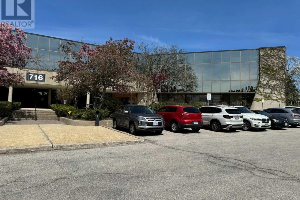 Exterior of 716 Gordon Baker Road building with cars parked in front. - 710 - 716 Gordon Baker Road, Toronto