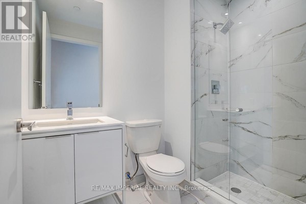 Wide apartment building hallway with marble floors, mirrored panels, and plush carpeting. - 710 - 77 Shuter Street, Toronto