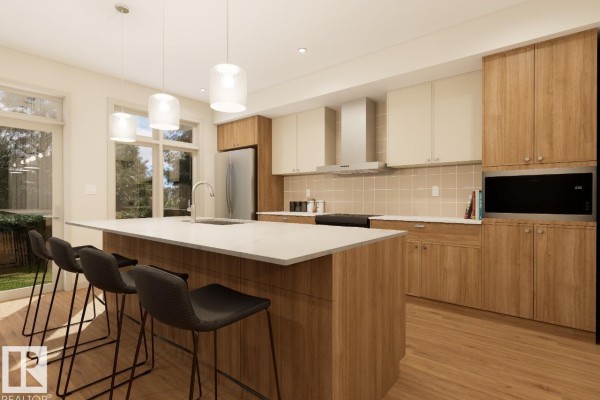 Kitchen with a large island, pendant lights, wood cabinets, stainless steel appliances, and bar stools. - 7107 50a Av, Beaumont