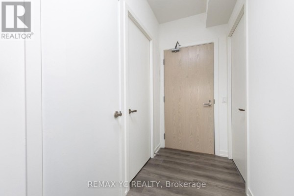 Entryway with white walls, two doors, and a light wood door - 7108 - 138 Downes Street, Toronto