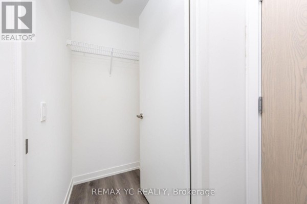 Small closet space with a wire shelf and white walls - 7108 - 138 Downes Street, Toronto