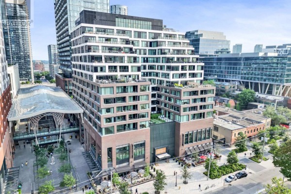 Exterior view of a contemporary condo building with brick and glass facade. - 711 - 455 Wellington Street W, Toronto