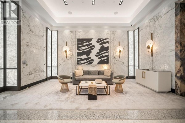 Luxurious lobby with marble walls, modern furniture, and abstract art. - 711 - 455 Wellington Street W, Toronto