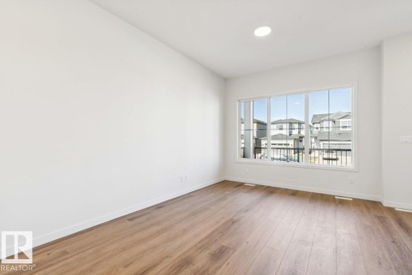 Family room - 7119 52 Av, Beaumont, AB T4X2Z7 Photo 4