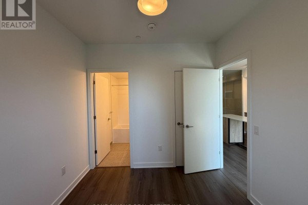 View of two doorways, one leading to a bathroom with a bathtub and the other to a study area. - 714 - 30 Dreamers Way, Toronto