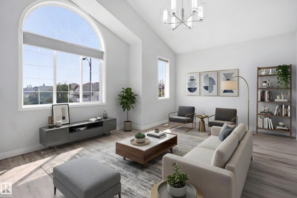 Family room with a sectional sofa, fireplace, television, and large window. - 714 87 Street Sw, Edmonton