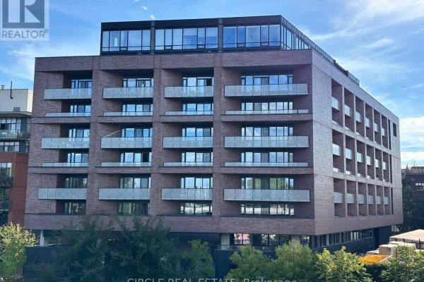 Full exterior view of a brick apartment building with balconies and glass windows. - 716 - 383 Sorauren Avenue, Toronto