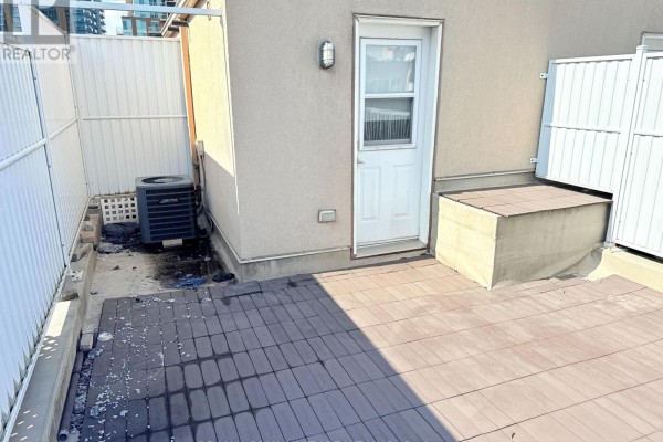 Outdoor air conditioning unit with debris and standing water next to a light beige wall. - 716 - 42 Western Battery Road, Toronto