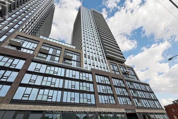 Exterior view of contemporary apartment building featuring glass windows and balconies. - 719 - 101 John Street N, Hamilton