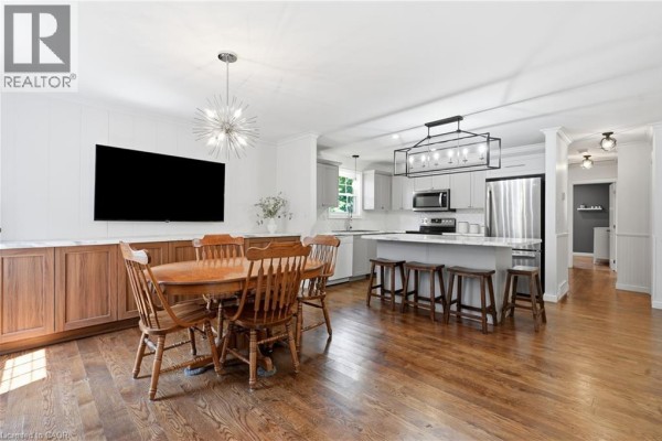 Open-concept living, dining, and kitchen area with hardwood floors and modern fixtures - 72 Crestlynn Crescent Simcoe