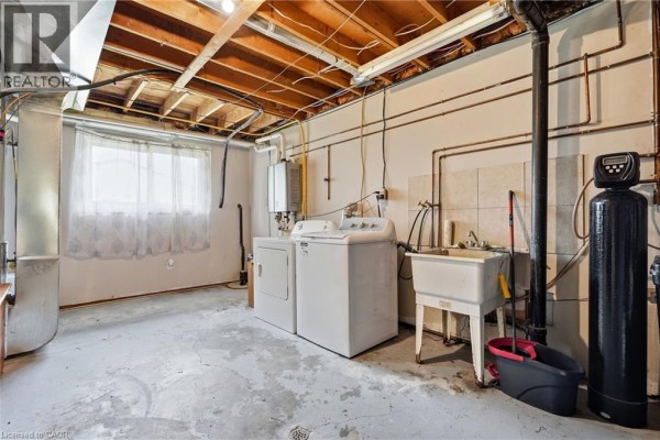 Washer, dryer, utility sink, and water softener in basement laundry room - 72 Crestlynn Crescent Simcoe