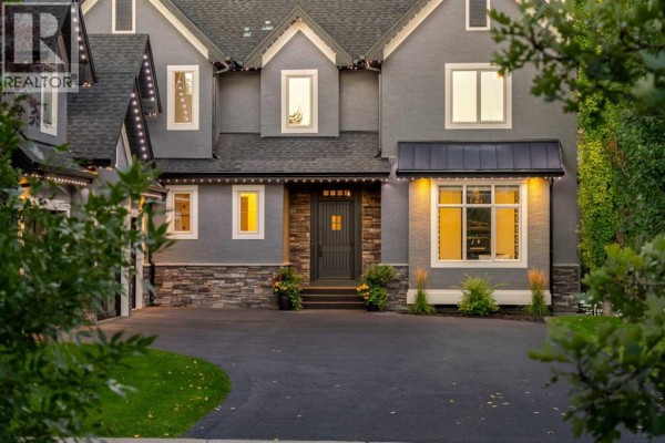 Close-up of the front entrance of a grey home with stone accents and large windows. - 72 Heritage Lake Shores, Heritage Pointe