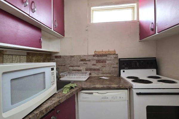 Basement laundry area with washer, dryer, and concrete walls - 72 Lebel Avenue, Kirkland Lake