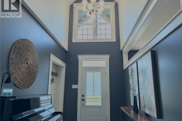 Interior entryway with dark blue walls, a piano, and a large window above the front door. - 72 Longwood Drive, Rothesay