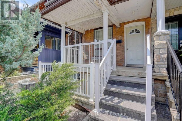 Detailed view of the porch steps and white railings at the entrance of the house. - 72 Symington Avenue, Toronto