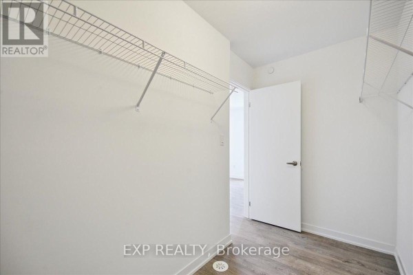 Empty walk-in closet with white walls and wire shelving on two sides. - 72 Turtle Island Road, Toronto