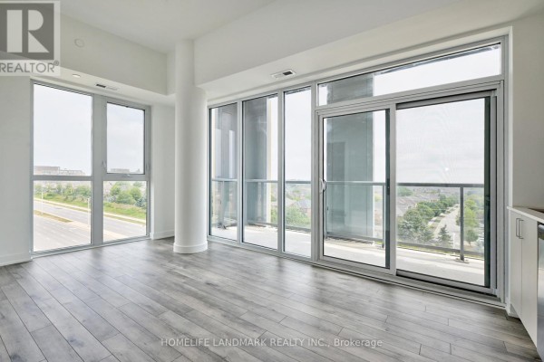 Living area with large windows and sliding glass doors offering a view of the street and neighborhood. - 720 - 1005 Dundas Street E, Oakville