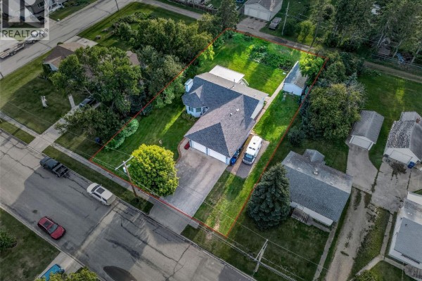 Aerial view of Rosthern, Saskatchewan, showing the house location between a high school and community school. - 720 6th Avenue, Rosthern