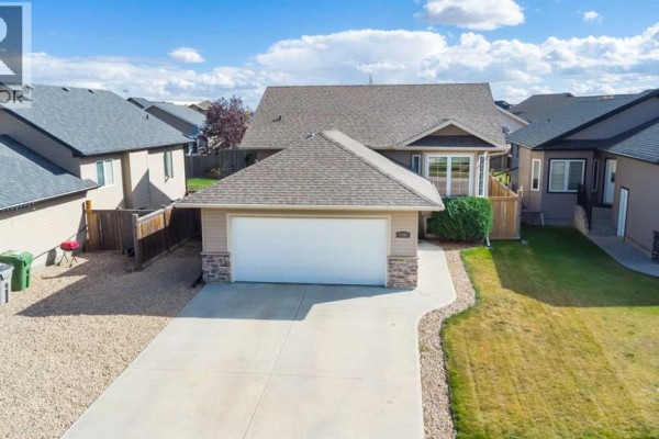 Aerial view of the front of a beige house with a two-car garage and driveway. - 7207 39a Street, Lloydminster