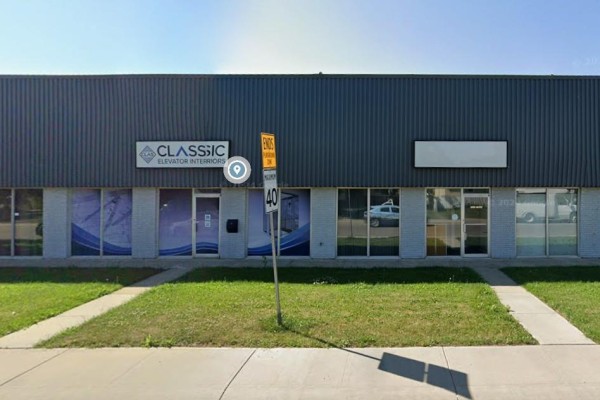 Front of a commercial building with large windows, signage for 'Classic Elevator Interiors', and green lawn. - 7217 77 Avenue Nw, Edmonton