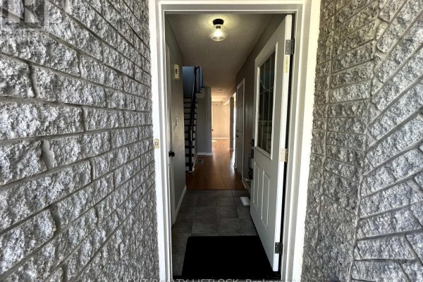 View from the front door looking down a hallway with a staircase on the left. - 722 Trailview Drive, Peterborough