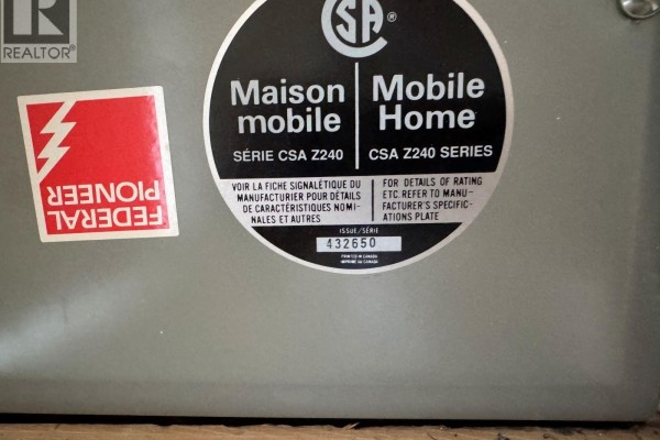Close-up of a CSA sticker on a grey panel indicating a mobile home, CSA Z240 series. - 7225 Boundary Drive Unit# 7, Grand Forks
