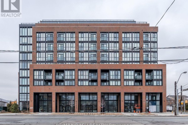 Front facade of a multi-story brick apartment building with retail spaces on the ground floor. - 723 - 2300 St Clair Avenue W, Toronto