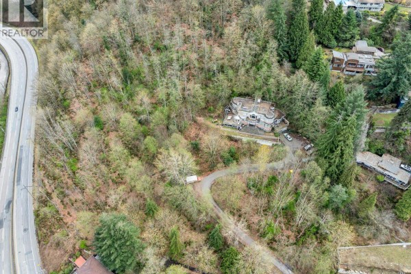 Close-up aerial view of 7235 Bayview Drive, showcasing the property layout and surrounding trees. - 7235 Bayview Drive, Burnaby