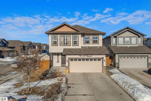 Wooden deck with stairs and a bench in a partially snow-covered backyard. - 724 40 Av Nw, Edmonton