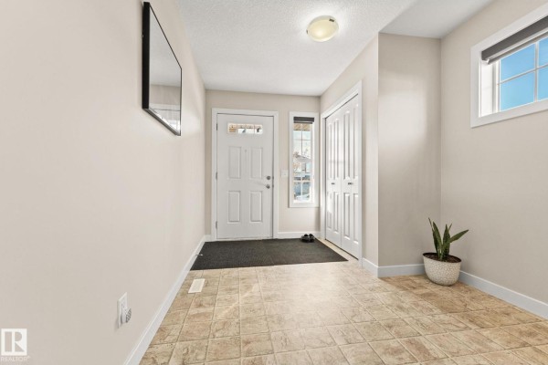 Dark brown exterior door with a window and security camera above. - 724 40 Av Nw, Edmonton