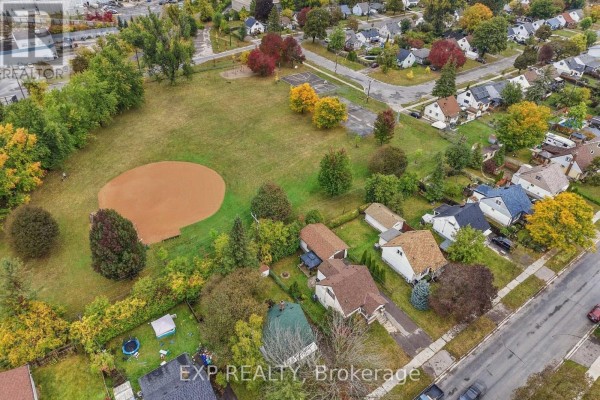 Aerial view of a neighborhood with a baseball diamond in a park and houses along the street. - 724 Mckellar Street, Peterborough