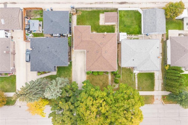 Aerial view of the property at 725 Mcleod Avenue, showing the house, garage, and surrounding lots. - 725 Mcleod Avenue, Winnipeg