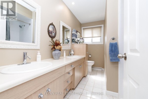 Bathroom with double vanity and decorative mirror - 7260 Mccoll Drive Niagara Falls