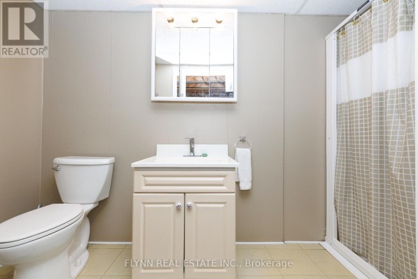 Bathroom with toilet, vanity, medicine cabinet, and shower curtain - 7260 Mccoll Drive Niagara Falls