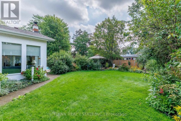 Grassy backyard with gazebo, trees, and fence - 7260 Mccoll Drive Niagara Falls