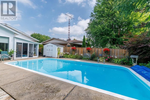 Swimming pool, sunroom, shed, and wooden fence - 7260 Mccoll Drive Niagara Falls