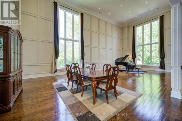 Formal dining room with a large table, six chairs, and tall windows flanking a grand piano. - 727 Sunset Beach Road, Richmond Hill