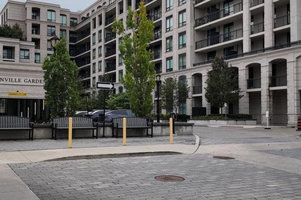 Paved walkway and benches outside the Unionville Gardens apartment buildings. - 728w - 268 Buchanan Drive, Markham