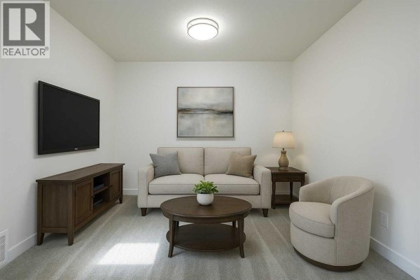 Cozy living room with a sofa, armchair, and wall-mounted TV in neutral tones - 729 Clearview Green, Chestermere